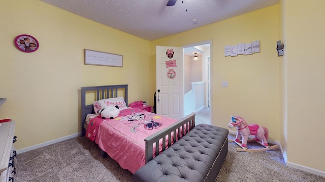 carpeted bedroom with a textured ceiling and ceiling fan