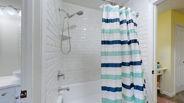 bathroom featuring shower / tub combo and vanity