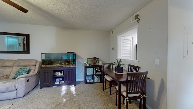 interior space with a textured ceiling and ceiling fan