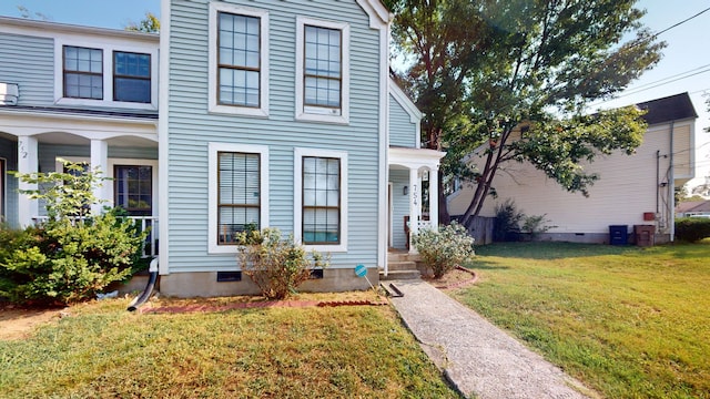 view of front of property featuring covered porch and a front lawn