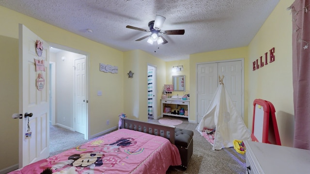 carpeted bedroom with a closet, ceiling fan, and a textured ceiling