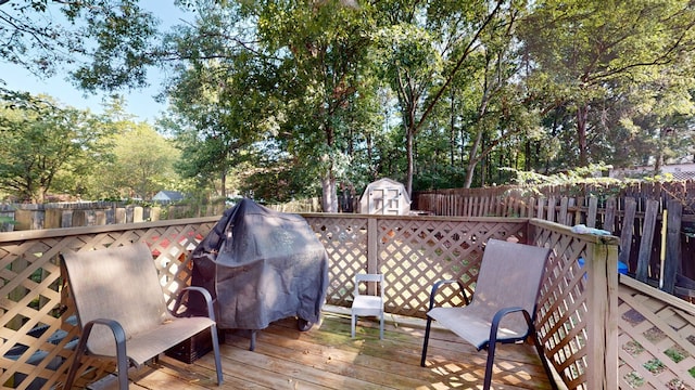 wooden deck with a storage shed