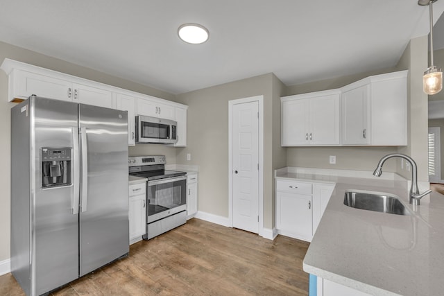 kitchen featuring sink, white cabinets, and appliances with stainless steel finishes