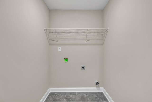 laundry room with hookup for an electric dryer, dark tile patterned floors, and washer hookup