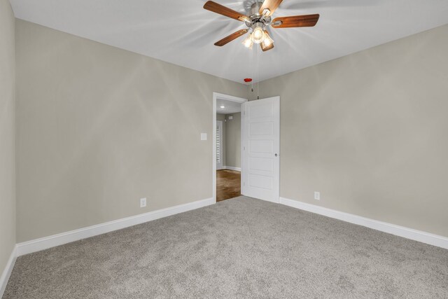 empty room featuring carpet floors and ceiling fan