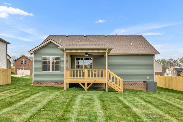 back of property featuring a deck, ceiling fan, a lawn, and central air condition unit