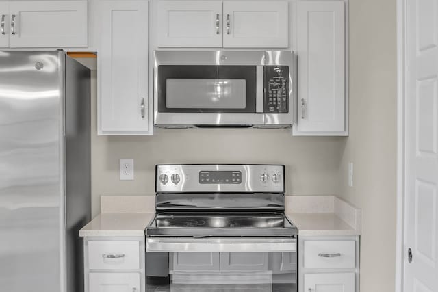 kitchen featuring appliances with stainless steel finishes and white cabinetry