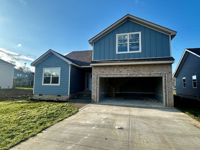 view of front of home featuring a garage and a front lawn