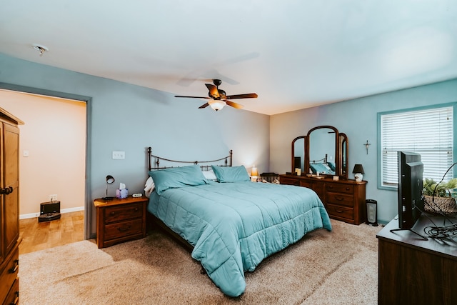 bedroom with ceiling fan and light hardwood / wood-style flooring