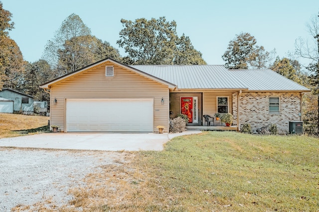 ranch-style house featuring a garage, a front yard, and central air condition unit