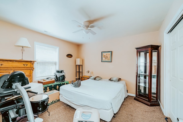 carpeted bedroom with a closet and ceiling fan