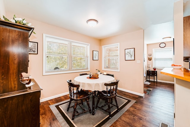 dining room with dark hardwood / wood-style flooring