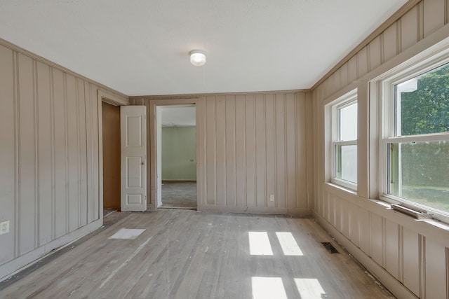 empty room with light hardwood / wood-style flooring