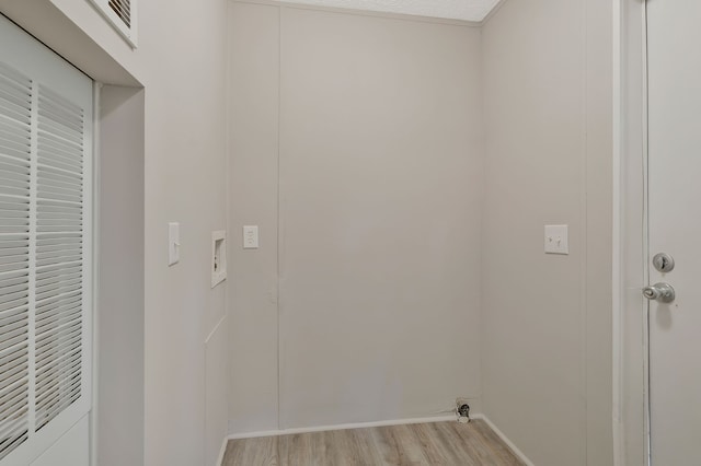 laundry area featuring light wood-type flooring and washer hookup