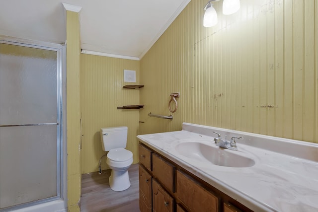 bathroom featuring an enclosed shower, hardwood / wood-style flooring, crown molding, toilet, and vanity