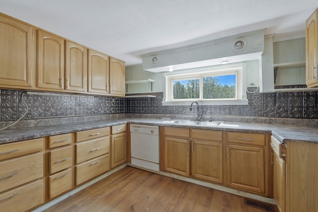 kitchen with dishwasher, sink, light wood-type flooring, and decorative backsplash