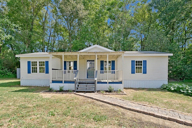 manufactured / mobile home with a porch and a front yard