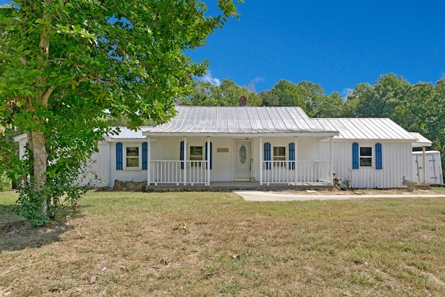 ranch-style house with a front lawn and covered porch