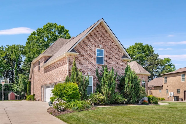 view of front of home with a front lawn and a garage