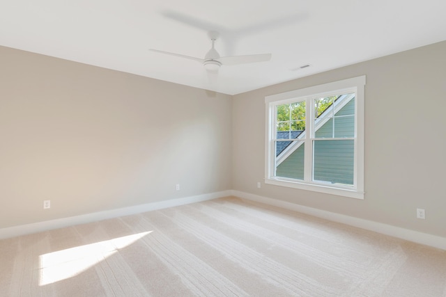 carpeted spare room with ceiling fan