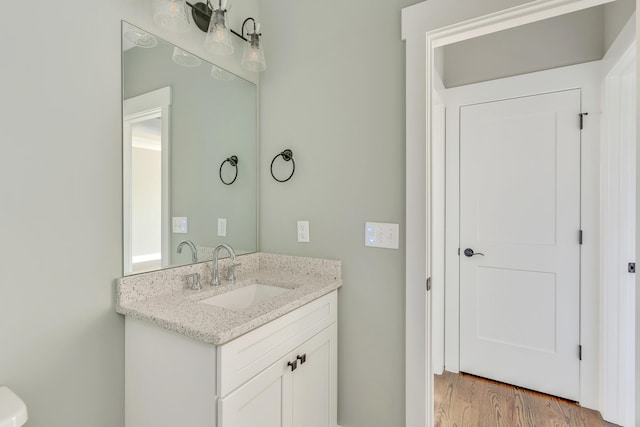 bathroom with vanity and hardwood / wood-style flooring