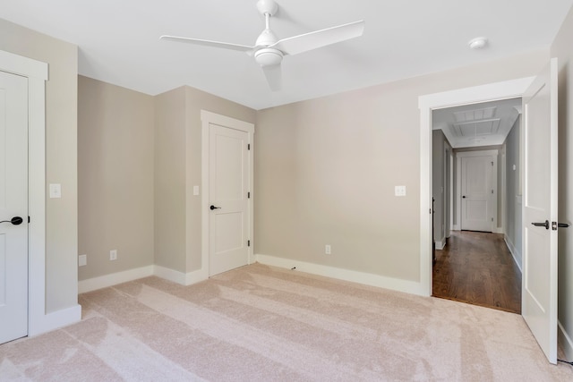 unfurnished bedroom with light carpet and ceiling fan