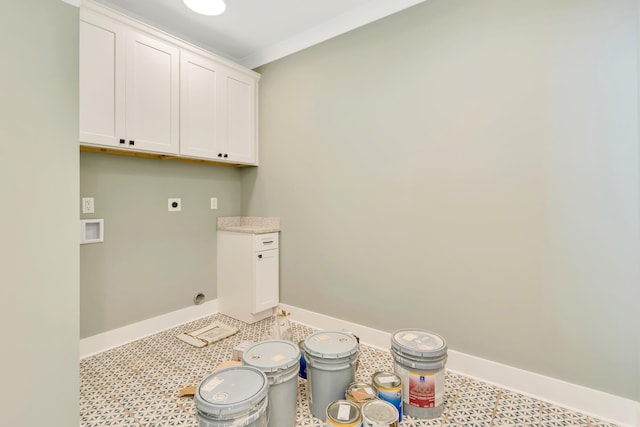 washroom featuring crown molding, hookup for a washing machine, electric dryer hookup, and cabinets