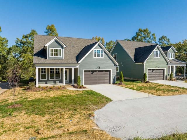 view of front of property with a front yard and a garage