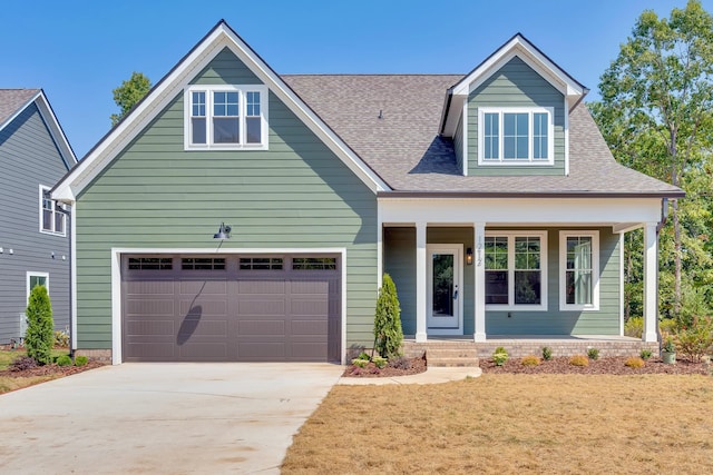 view of front of house with a porch and a garage