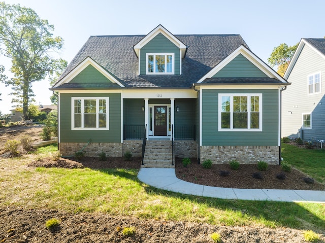 craftsman-style house with a porch and a front lawn