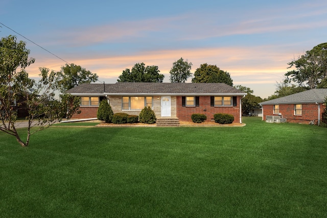 ranch-style house featuring a lawn