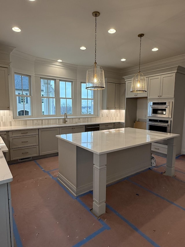 kitchen with light stone counters, backsplash, gray cabinets, a sink, and recessed lighting