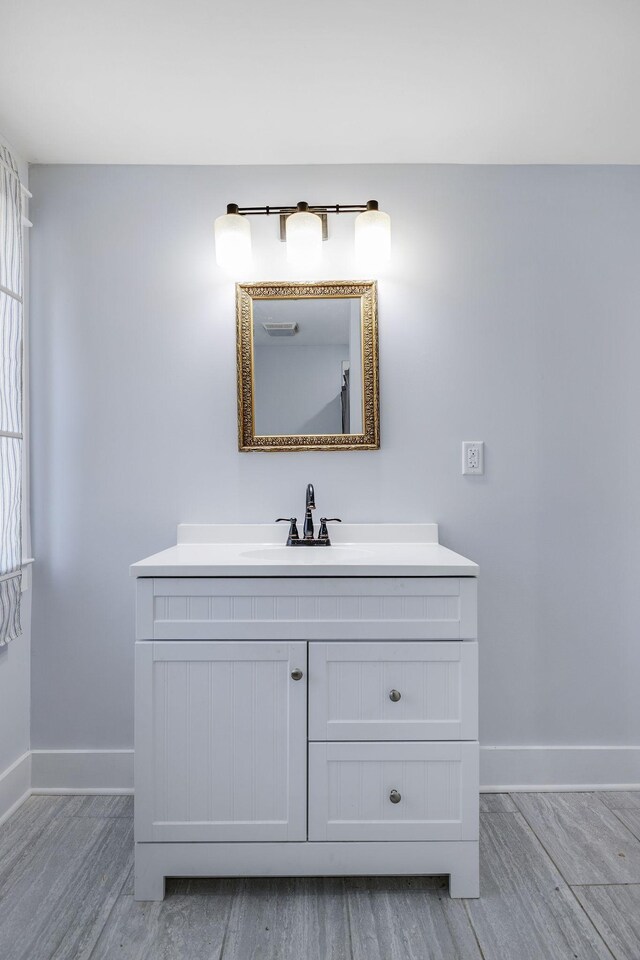 bathroom featuring hardwood / wood-style floors and vanity