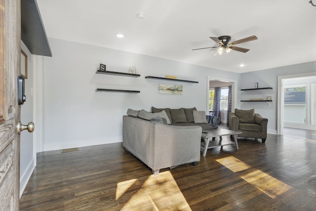 living room with ceiling fan and dark hardwood / wood-style flooring