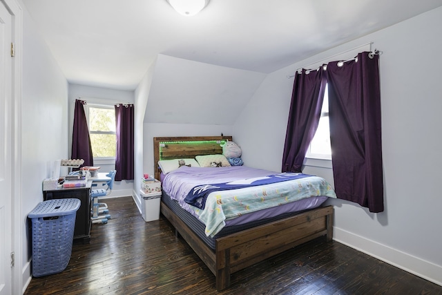 bedroom featuring dark hardwood / wood-style flooring and lofted ceiling