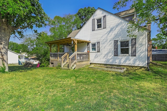 back of property with a lawn and covered porch