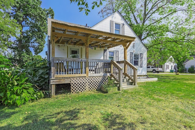 rear view of house with a yard