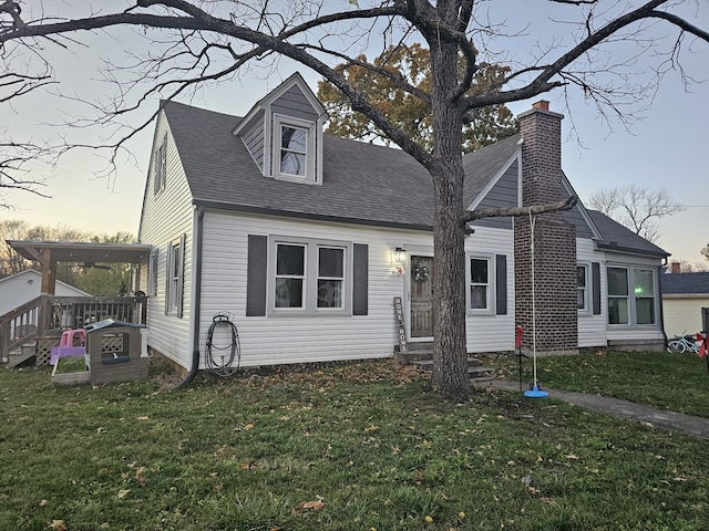 cape cod house with a yard