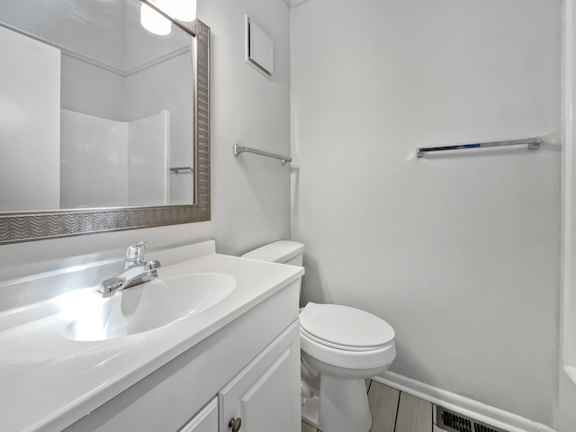 bathroom featuring toilet and vanity