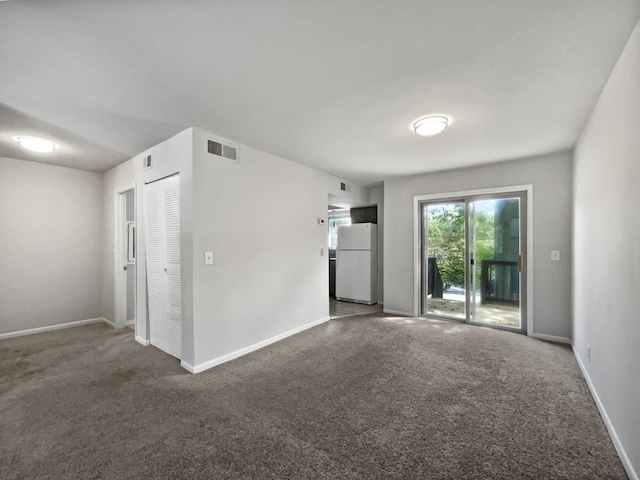 empty room featuring dark colored carpet