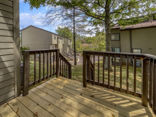 wooden terrace featuring a yard