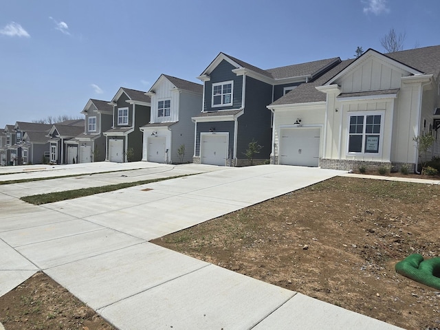 view of front of property featuring concrete driveway, board and batten siding, and a residential view