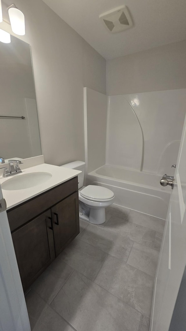 full bathroom with tile patterned floors, vanity, toilet, and shower / washtub combination