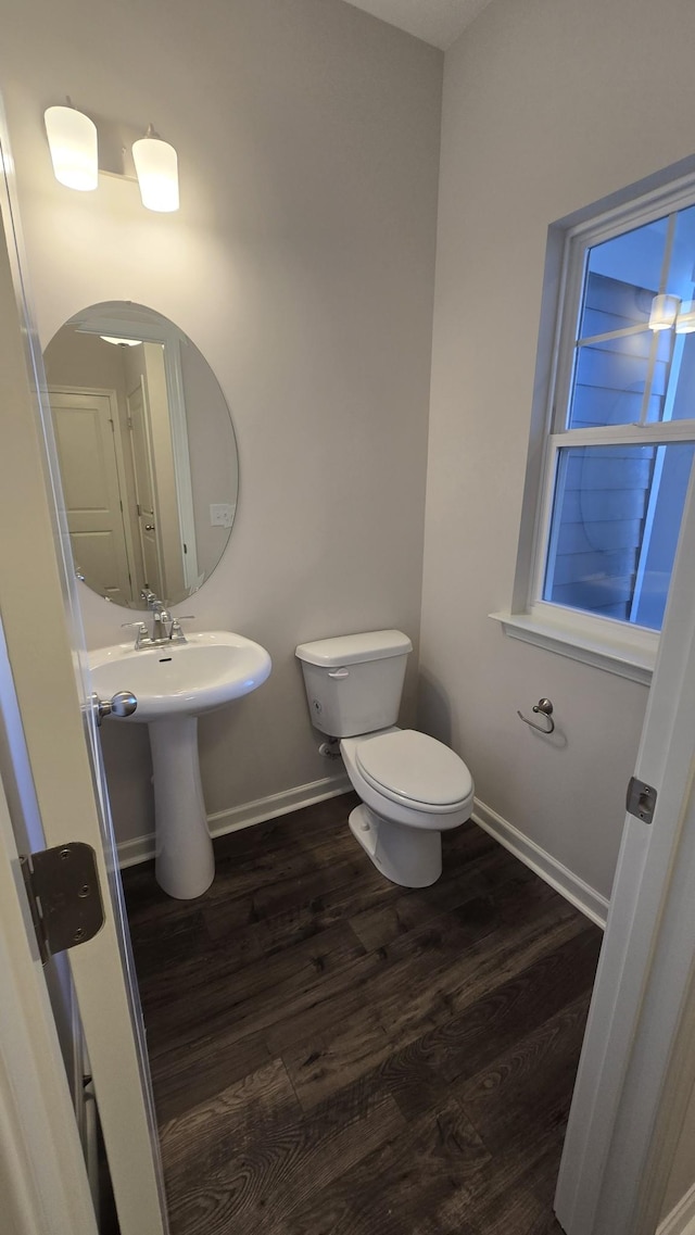 bathroom featuring hardwood / wood-style floors and toilet