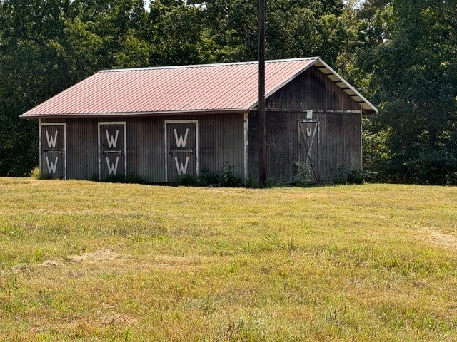 view of outbuilding featuring a yard