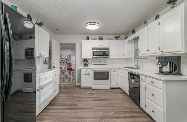 kitchen with sink, black appliances, white cabinetry, a textured ceiling, and dark hardwood / wood-style flooring