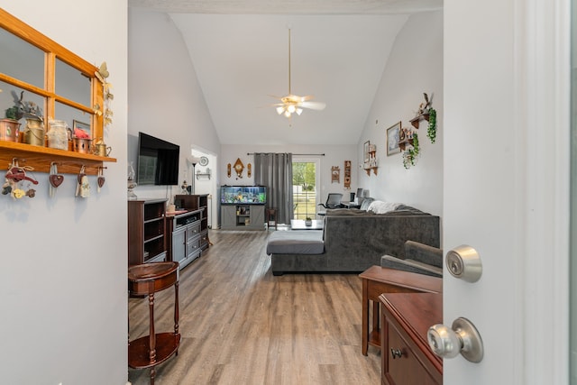 living room with hardwood / wood-style flooring, high vaulted ceiling, and ceiling fan