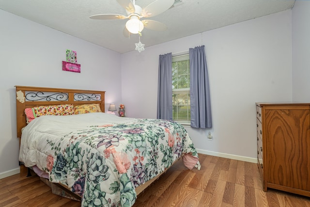 bedroom featuring a textured ceiling, hardwood / wood-style flooring, and ceiling fan