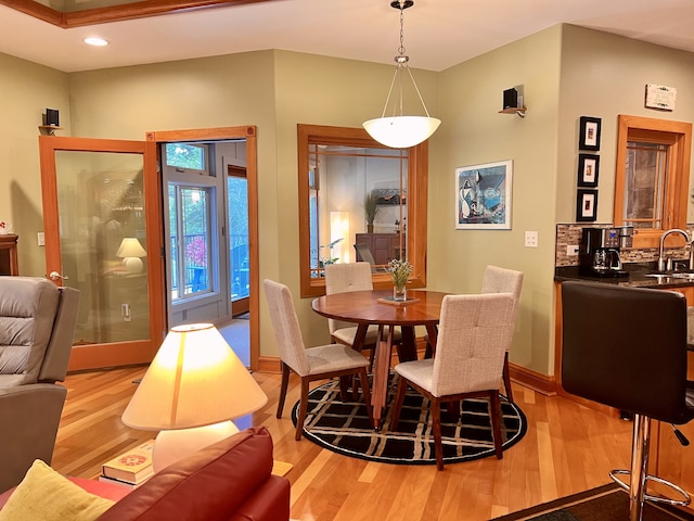 dining space featuring light hardwood / wood-style floors and sink