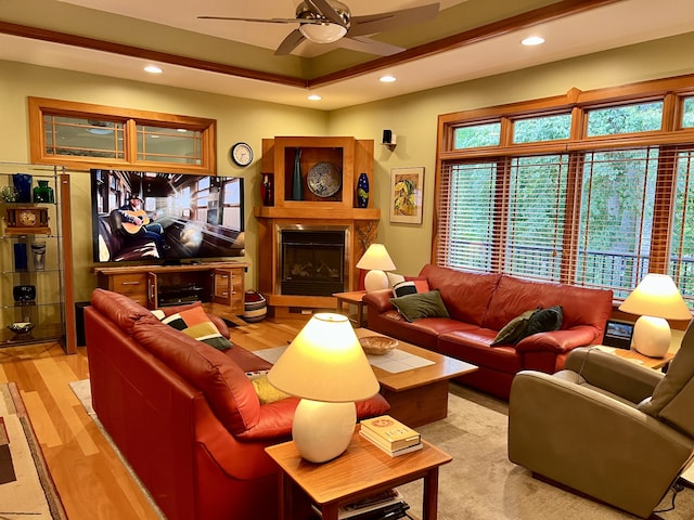 living room with light hardwood / wood-style flooring and ceiling fan